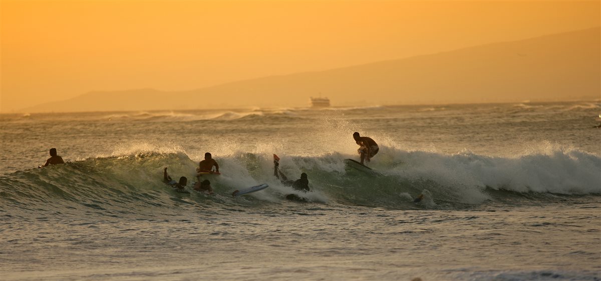 Surfer riding a wave at a coastal surf break