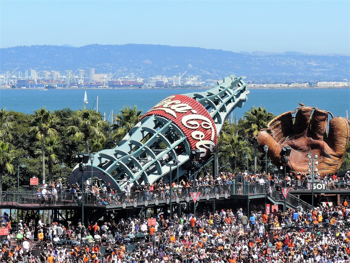 Baseball glove and ballpark scene representing spectator sports travel